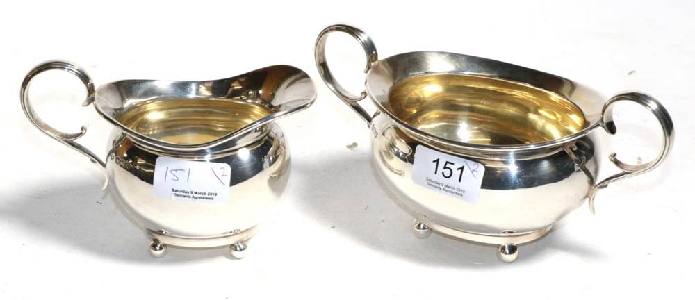 Lot 151 - A silver sugar bowl and cream jug, William Hutton, Sheffield 1921, oval on ball feet, 15.1ozt