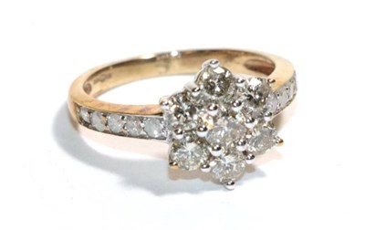 Lot 167 - A diamond cluster ring with inset shoulders, stamped '375', finger size H1/2