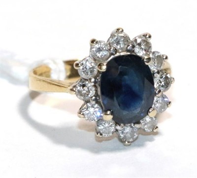 Lot 172 - An 18 carat gold sapphire and diamond cluster ring, finger size J