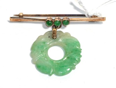 Lot 181 - A bar brooch stamped '9ct' with a jade bi-disc suspended, drop measures 3.5cm