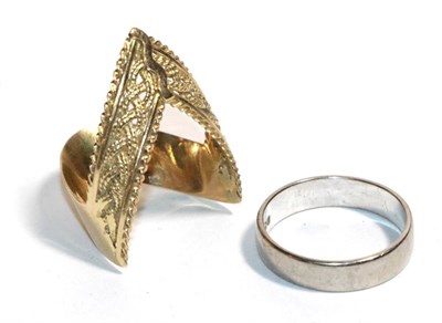 Lot 195 - A platinum band ring, finger size K; and a Middle Eastern yellow metal ring, finger size N (2)