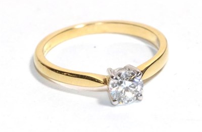 Lot 202 - An 18 carat gold solitaire diamond ring, a round brilliant cut diamond in a claw setting, to...