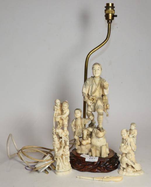 Lot 227 - A Japanese Meiji period ivory okimono, the wooden base drilled as a lamp; together with two further