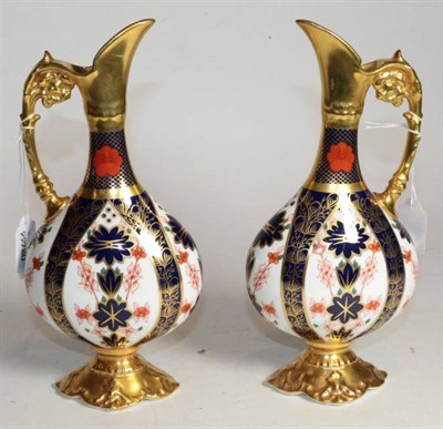 Lot 266 - A pair of Royal Crown Derby Imari pattern ewers, number 1128