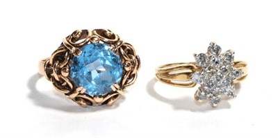 Lot 272 - A diamond cluster ring, stamped '10K', finger size K1/2; and a blue topaz ring, stamped '585',...