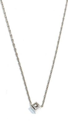 Lot 275 - A solitaire diamond pendant, on an 18 carat white gold chain, a princess cut diamond in a white...