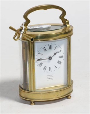 Lot 309 - An oval shaped brass carriage timepiece retailed by Asprey, Bond Street, London