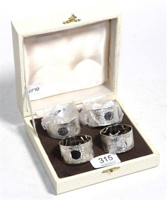 Lot 315 - A set of four silver napkin rings, Birmingham 2000, with engraved decoration, as new boxed, 3.6ozt