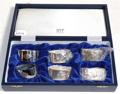 Lot 317 - A set of six Scottish silver napkin rings, Edinburgh 1997, with Celtic design, as new boxed, 5.8ozt