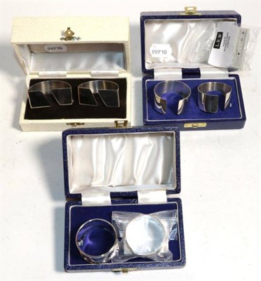 Lot 318 - Three various pairs of modern silver napkin rings, all as new and boxed, 4.4ozt