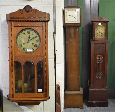 Lot 1009 - Two small striking longcase clocks and a 1920s oak striking wall clock (3)