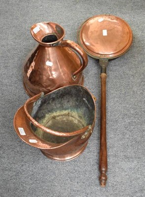 Lot 1012 - A large copper jug; a copper coal helmet; and a warming pan