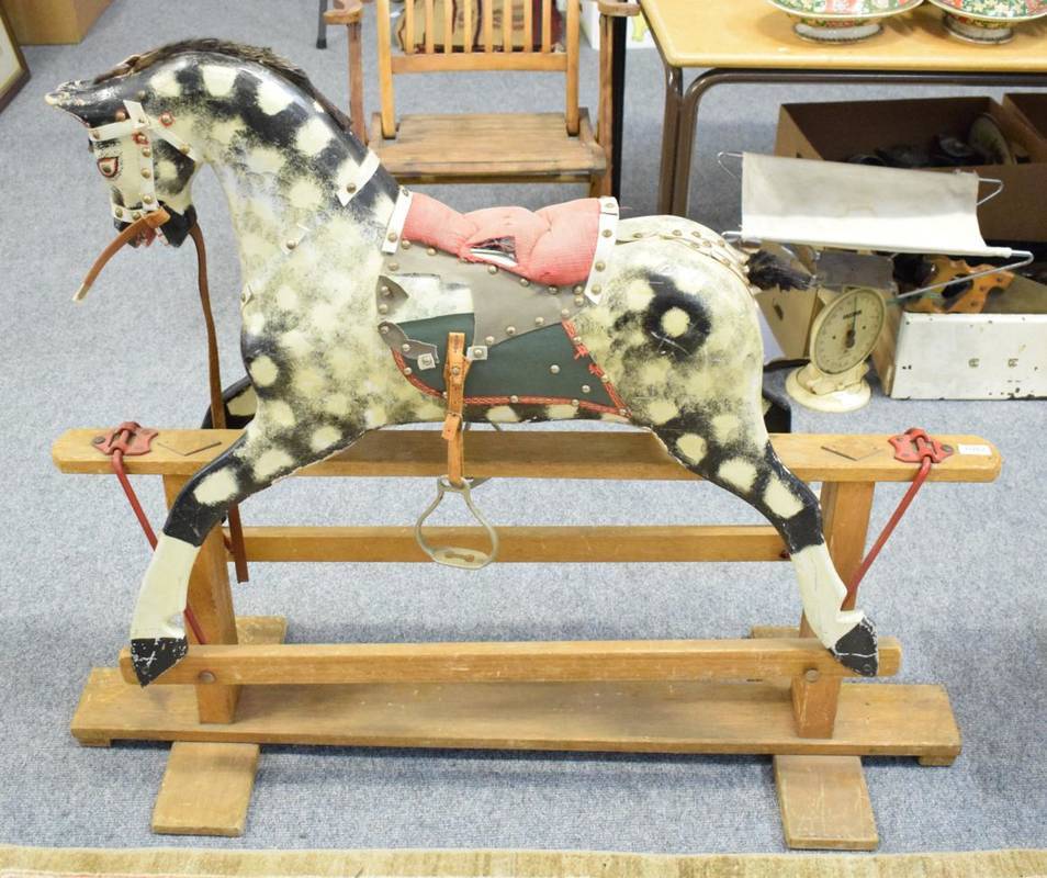 Lot 1082 - A late 19th/early 20th century painted wooden dapple grey rocking horse on trestle base