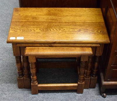 Lot 1204 - A nest of three oak tables