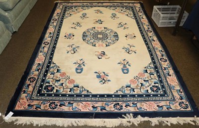 Lot 1224 - Chinese carpet, the ivory field centred by a roundel, surrounded by towest motifs, enclosed by pale