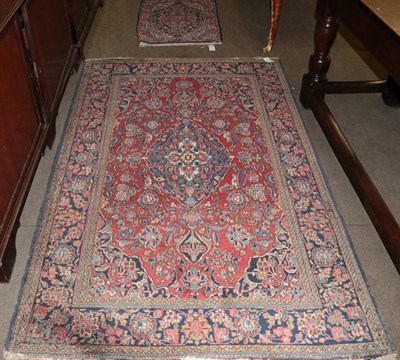 Lot 1230 - Kashan rug, the raspberry field centred by indigo medallion, enclosed by meandering vine...