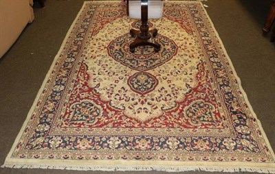 Lot 1231 - Indian Carpet, the cream field of vines centred by a medallion framed by indigo borders, 293cm...