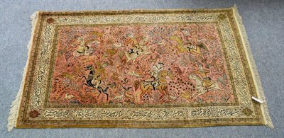 Lot 1237 - Ghom style silk rug, the salmon pink field depicting a hunting scene, enclosed by cartouche borders