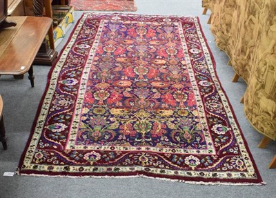 Lot 1241 - Unusual Oriental carpet, the field with urns issuing flowers, enclosed by meandering vine...