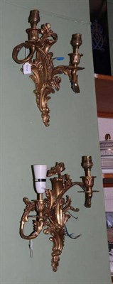 Lot 1264 - A seven arm gilt bronze electrolier and a pair of gilt bronze wall lights of Rococo design (3)