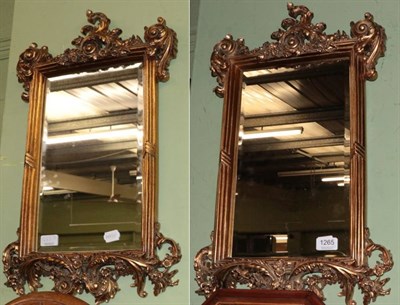 Lot 1265 - A pair of gilt bevelled glass mirrors (modern)