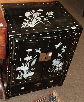 Lot 1289 - A Chinese style black lacquered and mother of pearl inlaid two door cabinet