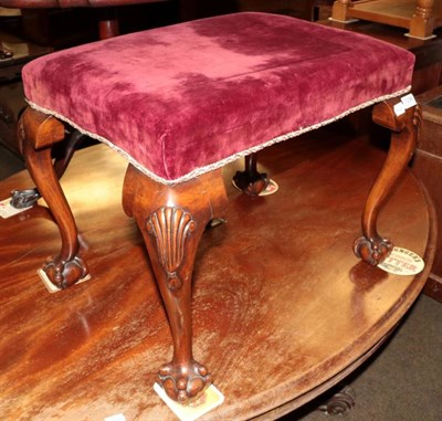 Lot 1296 - A carved mahogany dressing stool in the George III style, with purple velvet seat and shell...