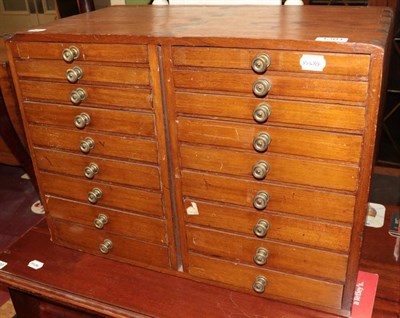 Lot 1301 - An early 20th century eighteen drawer index cabinet with graduated drawers