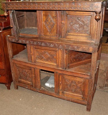 Lot 1319 - An early 18th century joined oak press cupboard with carved cupboard doors