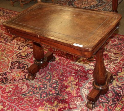 Lot 1322 - A mid-19th century rosewood writing table, with inset leather top, fitted with two drawers, on...