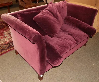 Lot 1330 - A two-seater sofa, modern, upholstered in purple plush velvet with assorted scatter cushions...