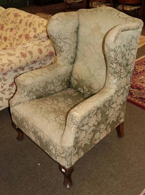 Lot 1352 - A George III style wing chair