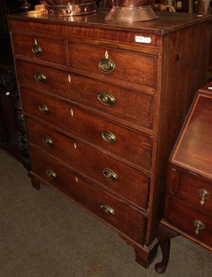 Lot 1363 - A George III oak six drawer straight fronted chest on bracket feet