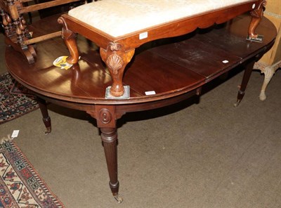 Lot 1372 - A 19th century mahogany wind out dining table, with two additional leaves, on reeded legs