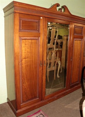 Lot 1377 - A late 19th century walnut triple door wardrobe in the manner of Gillows