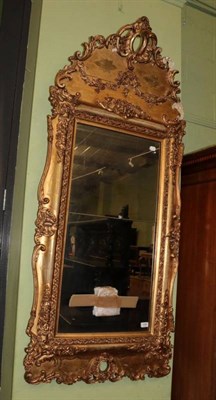 Lot 1381 - A carved giltwood and gesso mirror, 2nd quarter 19th century, the mercury plate in two sections...