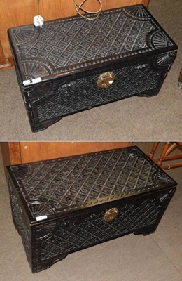 Lot 1387 - A carved and ebonised blanket box together with a matching smaller example (2)