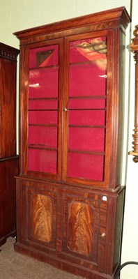 Lot 1389 - A Victorian mahogany bookcase, the upper section with glazed doors, the base as a cupboard door