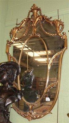 Lot 1393 - A reproduction gilt shield shaped mirror