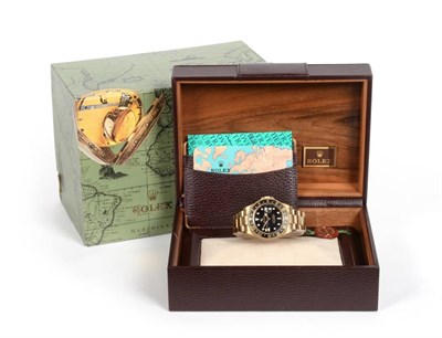 Lot 93 - An 18ct Gold Dual Time Zone Automatic Calendar Centre Seconds Wristwatch, signed Rolex, Oyster...