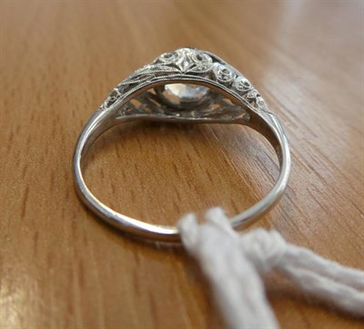 Lot 102 - A Diamond Solitaire Ring, an old cut diamond in a claw setting, to fancy scroll pierced...