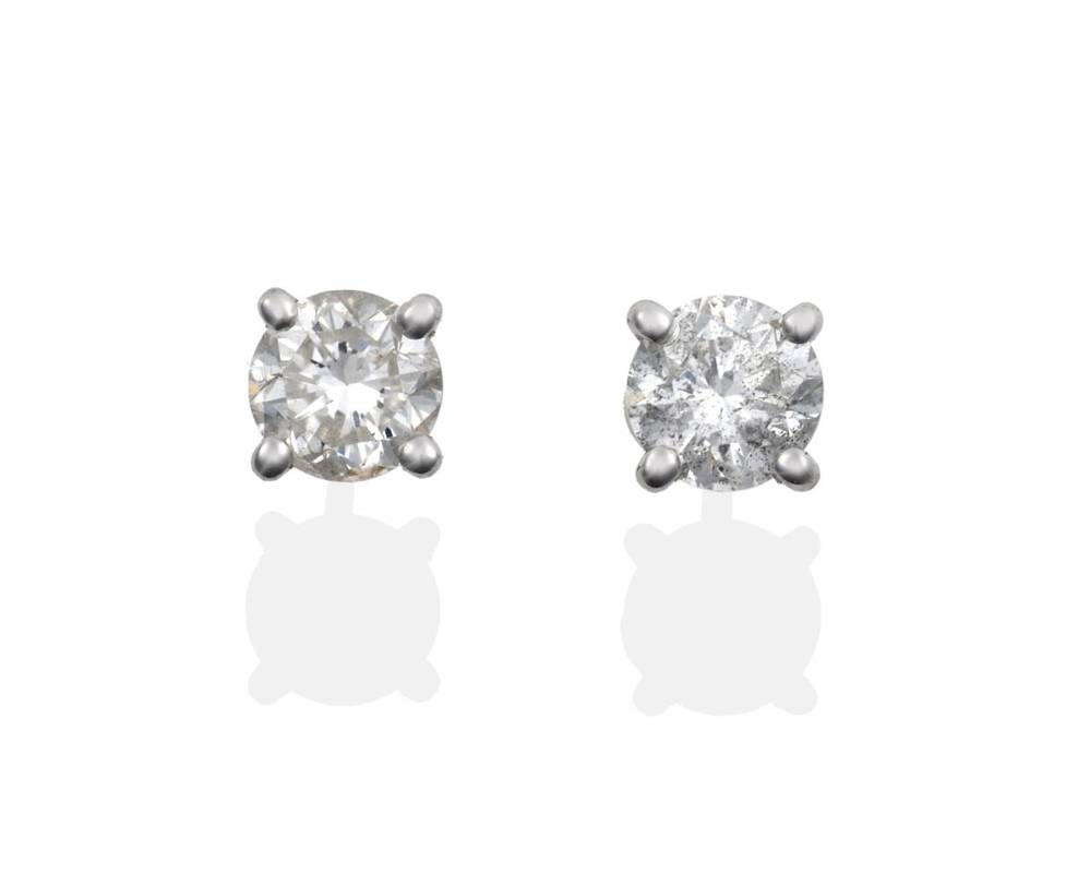 Lot 104 - A Pair of Diamond Solitaire Stud Earrings, the round brilliant cut diamonds in four claw...