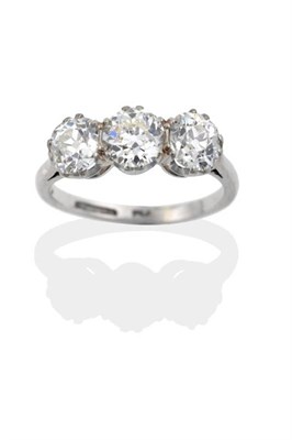 Lot 106 - A Diamond Three Stone Ring, the old cut diamonds in white claw settings to a pointed shoulder plain