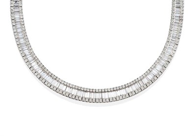 Lot 118 - An 18 Carat White Gold Diamond Necklace, channel set baguette cut diamonds between bands of...