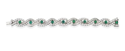 Lot 121 - An Emerald and Diamond Bracelet, oval and round cut emeralds in claw settings, within baguette...