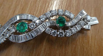 Lot 121 - An Emerald and Diamond Bracelet, oval and round cut emeralds in claw settings, within baguette...