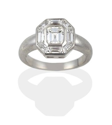 Lot 123 - A Platinum Emerald-Cut and Baguette Cut Diamond Cluster Ring, an emerald-cut diamond within a...