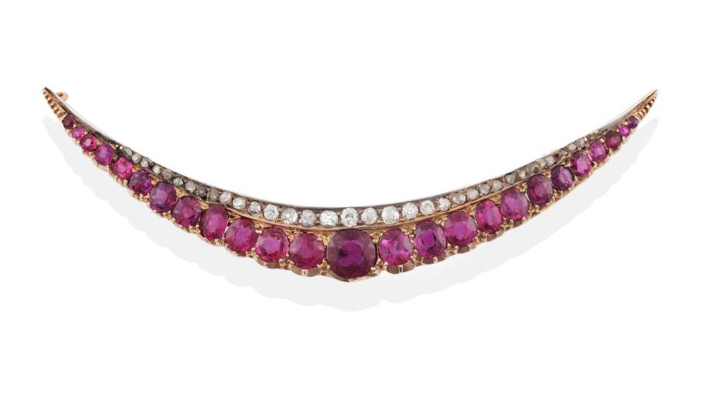 Lot 125 - A Ruby and Diamond Crescent Brooch, circa 1900, the graduated oval and cushion shaped rubies on the