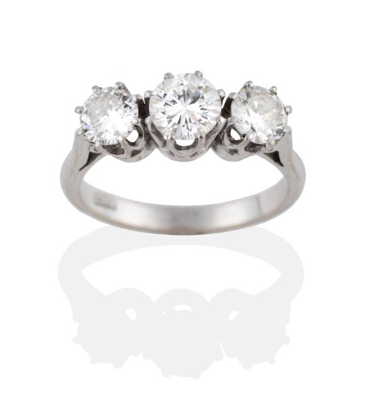 Lot 131 - A Diamond Three Stone Ring, the round brilliant cut diamonds in white claw settings to a...
