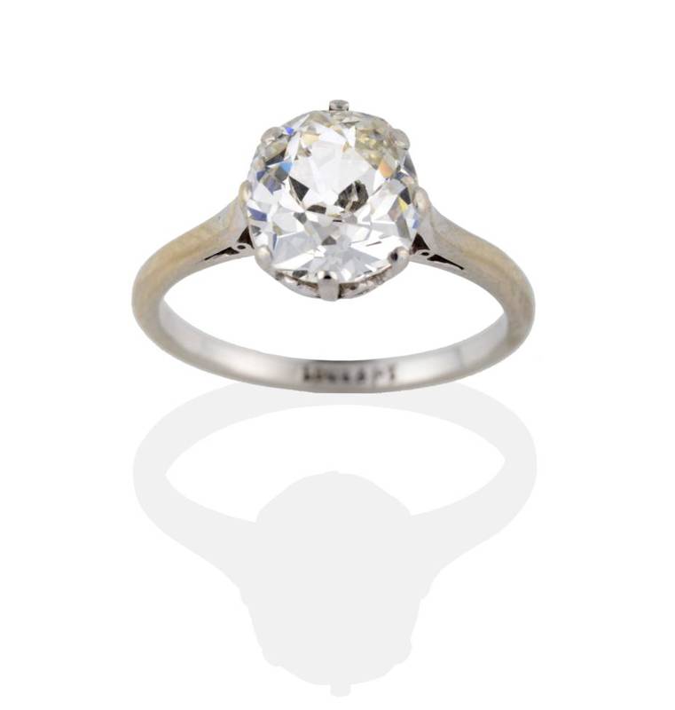 Lot 133 - A Diamond Solitaire Ring, the cushion shaped old cut diamond in a white claw setting to pointed...